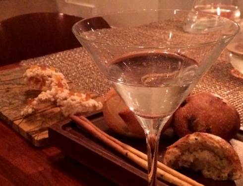 A dirty martini accompanied by the delicious bread and amazing concoction